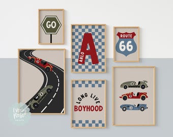 May include: A collection of framed wall art featuring a racing theme. The art includes images of race cars, a Route 66 sign, a checkered pattern, and the text "GO" and "Long Live Boyhood". The color palette includes red, blue, and beige.