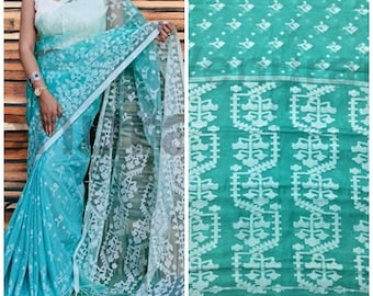 May include: A teal blue saree with a white floral pattern. The saree is made of a sheer fabric and has a delicate, intricate design.