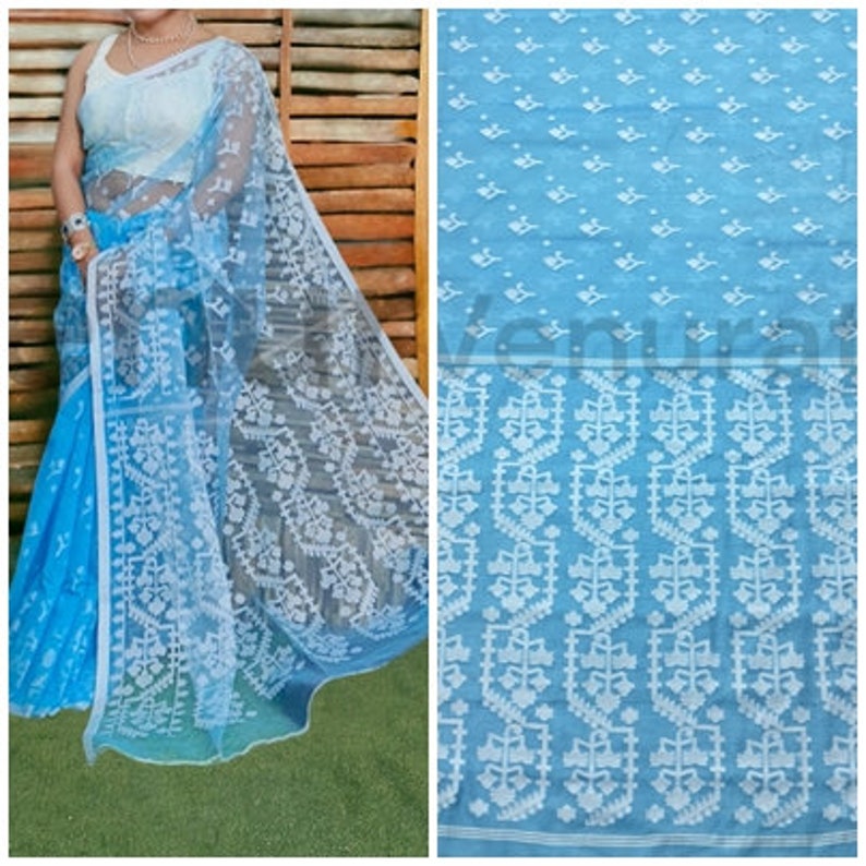 May include: A light blue sheer saree with a white floral pattern. The saree has a delicate, intricate design and is perfect for special occasions.