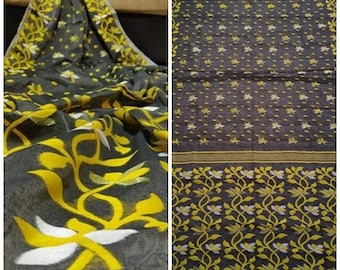 May include: A gray and yellow saree with a floral pattern. The saree has a thin border with a repeating pattern of leaves and flowers.
