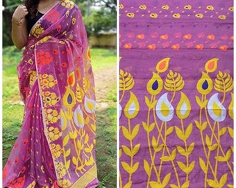 May include: A pink and yellow floral patterned saree with a sheer fabric. The saree has a floral design with yellow flowers and leaves on a pink background.