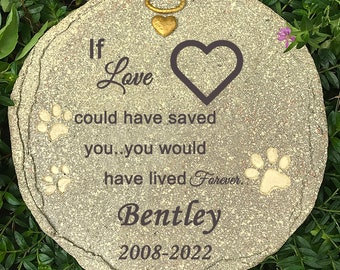 May include: A round, stone pet memorial with the text "If Love could have saved you, you would have lived Forever." Includes a heart, paw prints, and the name "Bentley" with dates 2008-2022. A gold-colored halo and heart charm are attached.