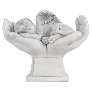 May include: White ceramic memorial sculpture of a sleeping angel dog with wings resting in cupped hands. The sculpture has a blank plaque for personalization.