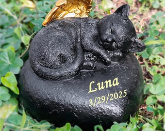 May include: Black cat memorial figurine with gold wings, sleeping on a heart-shaped stone with the inscription "Luna 3/29/2025".