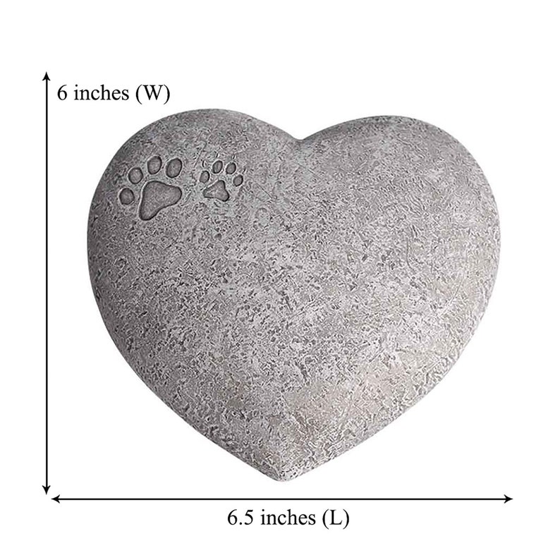 May include: A grey heart-shaped stone memorial with two paw prints. The stone measures 6.5 inches long and 6 inches wide.