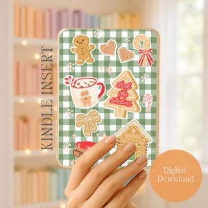 May include: Kindle Insert with a green and white checkered background, featuring gingerbread cookies, a Christmas tree, and a mug of hot cocoa. The text "Deck the Shelves" is on the tree. The words "Kindle Insert" and "Digital Download" are also visible.