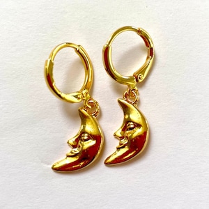 gold crescent moon face huggie earrings