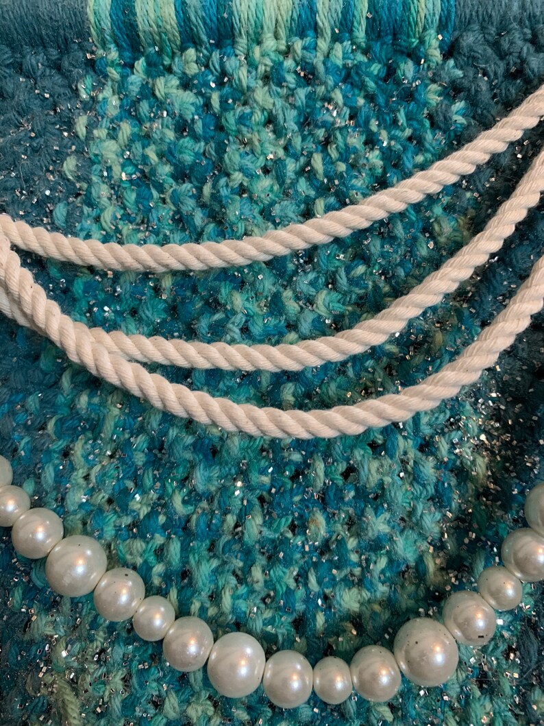 glitter and twine embellishments hanging from a wood dowel rod Handmade macrame mermaids tail wall hanging wfaux pearls