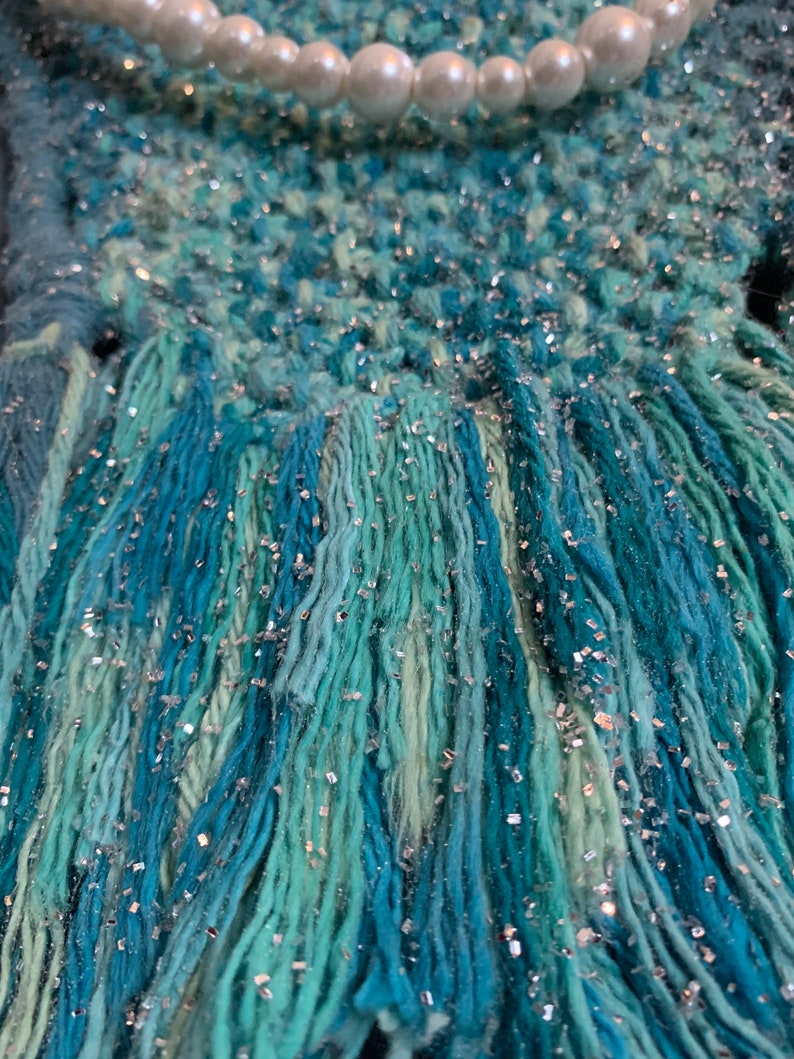 glitter and twine embellishments hanging from a wood dowel rod Handmade macrame mermaids tail wall hanging wfaux pearls