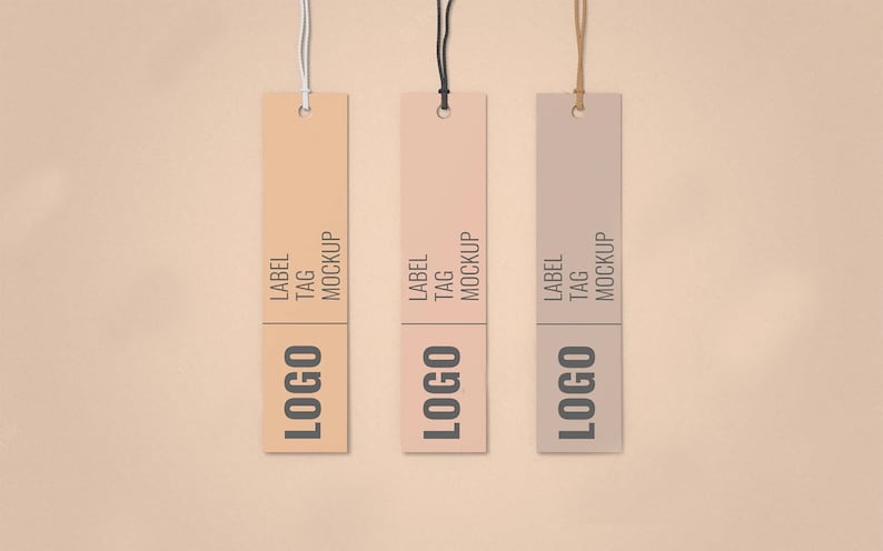 May include: Three hanging tags with a light brown, peach, and gray background. Each tag has the text "LABEL TAG MOCKUP" and the word "LOGO" in a black font.