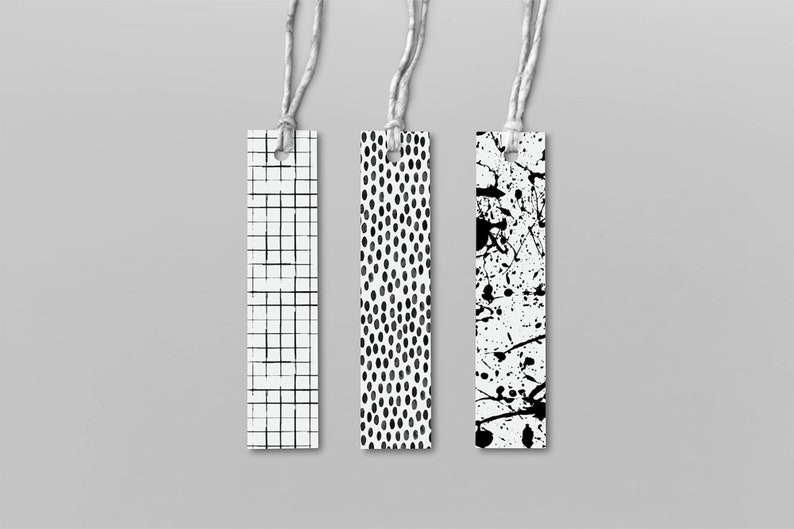 May include: Three black and white patterned bookmarks with string attached. The bookmarks feature a grid pattern, a polka dot pattern, and a splatter paint pattern.