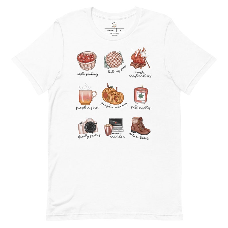 May include: White t-shirt with a graphic design of nine fall-themed icons. The icons include apple picking, baking pies, roasting marshmallows, pumpkin spice, pumpkin carving, fall candles, family photos, movie marathon, and nature hikes.