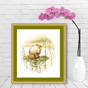 May include: A framed cross-stitch illustration of a frog sitting on a lily pad and fishing with a rod. The frog is wearing a white shirt and brown trousers. The background is a green and blue landscape with a pond.