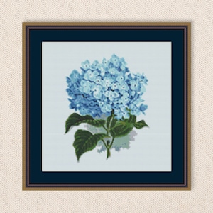 May include: A cross-stitch pattern of a blue hydrangea flower with green leaves. The flower is in a white frame with a dark blue mat.