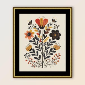 Puede incluir: Un bordado de punto de cruz enmarcado que presenta un ramo floral estilizado con flores naranjas, amarillas y negras sobre un fondo blanco.