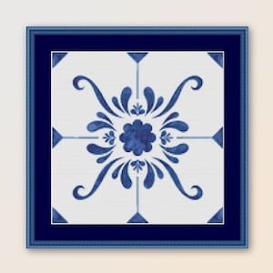May include: A framed blue and white tile with a floral design. The tile is in a blue frame and has a white background with a blue floral pattern.