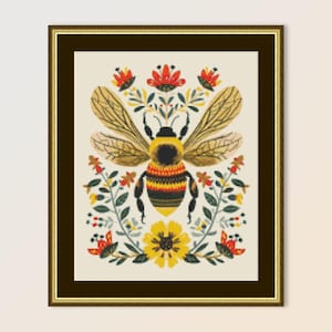 May include: A framed cross-stitch embroidery depicting a stylised bumblebee with yellow and black stripes surrounded by red, yellow and green flowers.