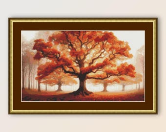 May include: A framed cross-stitch artwork depicting a large, orange-red tree in a forest setting. The tree is the focal point of the image, with its branches reaching out towards the viewer. The background is a soft, hazy blue, suggesting a misty morning or evening.