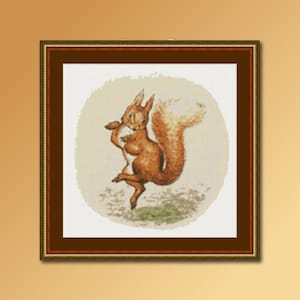 May include: A framed cross-stitch of a dancing squirrel. The squirrel is depicted in shades of brown and orange, with a fluffy tail and a playful pose. The background is a light beige circle, and the frame is a dark brown color.