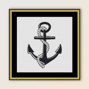 May include: A black anchor with a white rope wrapped around it. The anchor is in a gold frame.