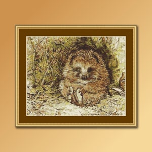 May include: A brown and white hedgehog curled up in a nest of leaves and twigs. The hedgehog has a small, pointed nose and tiny black eyes.