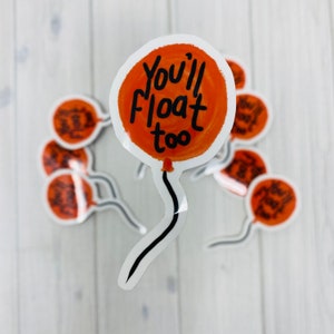 Peut inclure: Un ensemble d'autocollants de ballons orange avec le texte "You'll float too" écrit en noir.