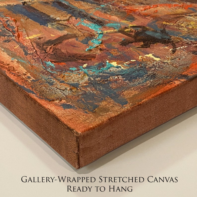 May include: Close-up of the side of a gallery-wrapped stretched canvas painting. The canvas is painted with abstract shapes in shades of brown, orange, blue, and turquoise. The text "GALLERY-WRAPPED STRETCHED CANVAS READY TO HANG" is printed on the white background below the canvas.