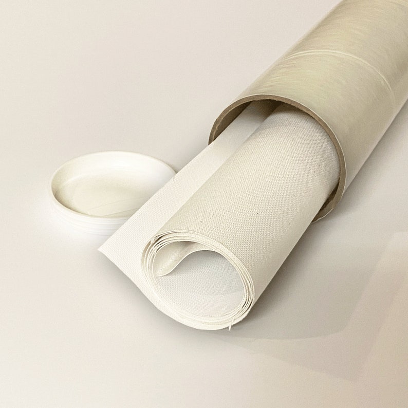 May include: A white canvas roll is partially unrolled and is being stored in a cardboard tube. The canvas is rolled up tightly and the tube is made of cardboard with a clear plastic covering.