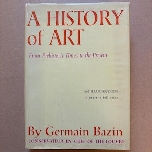 May include: A hardcover book titled A History of Art: From Prehistoric Times to the Present by Germain Bazin, Conservateur-en-Chef of the Louvre. The cream-colored cover features red text, noting 668 illustrations and 14 pages in full color.