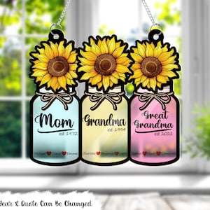 May include: Three mason jar-shaped ornaments with sunflowers and the words "Mom est 1972", "Grandma est 1994", and "Great Grandma est 2022".