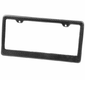 May include: A rectangular license plate frame with a carbon fiber weave pattern. The frame is black and has a textured surface. It has two holes at the top and one on each side for mounting.