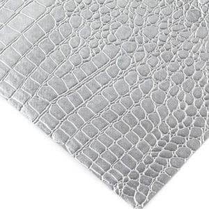 May include: Close-up of a gray, textured material with a crocodile skin pattern. The pattern is made up of irregular, interconnected shapes, creating a realistic reptile skin effect. The material is a light gray color.