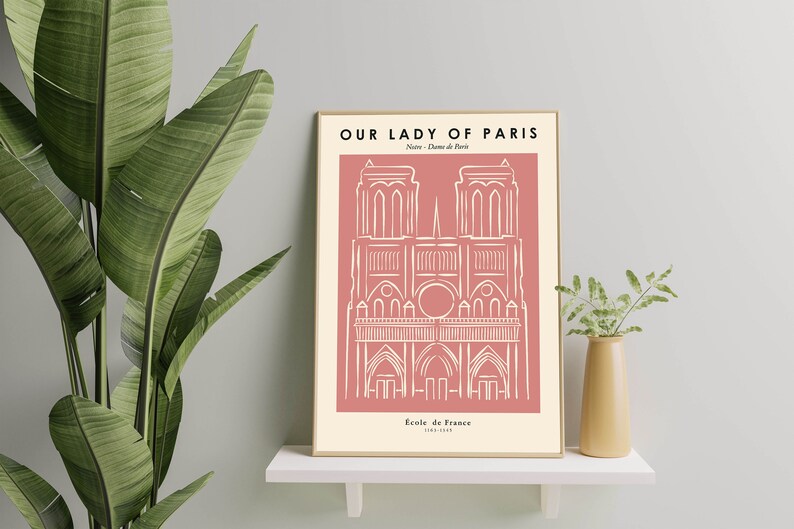 May include: A pink and white minimalist line art print of Notre Dame Cathedral in Paris, France. The print has the text "Our Lady of Paris" and "Notre Dame de Paris" at the top and "Église de France 1163-1345" at the bottom.