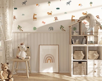 May include: A white wall with a variety of animal and jungle themed wall decals. The decals include a toucan, a zebra, a monkey, a lion, a giraffe, a koala, a palm tree, and an elephant. There is a white shelf unit with a dollhouse and baskets on it. There is a white unicorn stuffed animal sitting on a wooden chair. There is a framed print of a rainbow on the wall.