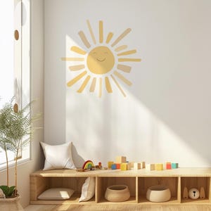 May include: A cheerful yellow sun wall decal with a smiling face adorns a white wall. The room features a wooden bench with pillows, baskets, and colorful wooden blocks, creating a playful and inviting space.