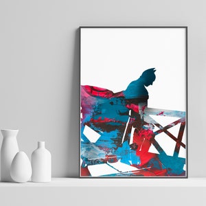 Puede incluir: Impresión de arte abstracto con una silueta de Batman en pintura azul, roja y negra. La imagen está enmarcada y lista para colgar.