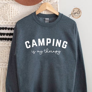 May include: A dark heather gray sweatshirt with the text "CAMPING is my therapy" in white.