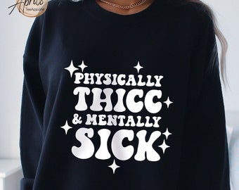 May include: Black sweatshirt with white text that reads "PHYSICALLY THICC & MENTALLY SICK" in a retro font with stars around the text.