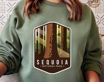 May include: A green sweatshirt with a brown and green graphic of a sequoia tree and the text "Sequoia National Park".