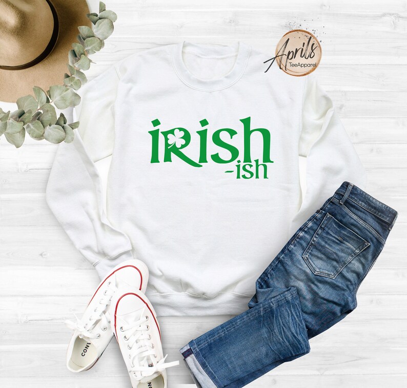 May include: White sweatshirt with green text that reads "irish-ish" with a shamrock graphic.