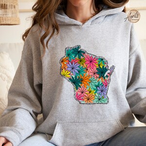 May include: A gray hoodie with a floral design of the state of Wisconsin. The flowers are in shades of pink, orange, yellow, green, and purple.