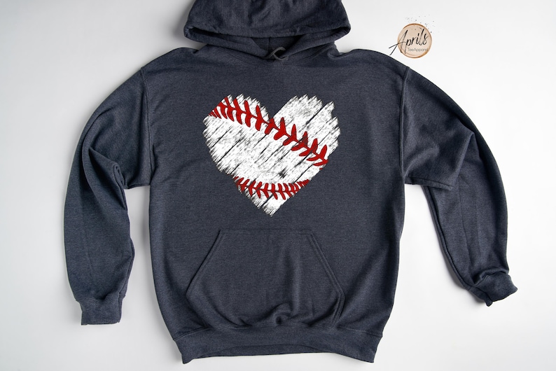 May include: A dark blue hooded sweatshirt with a white distressed baseball heart graphic. The baseball heart has red stitching.