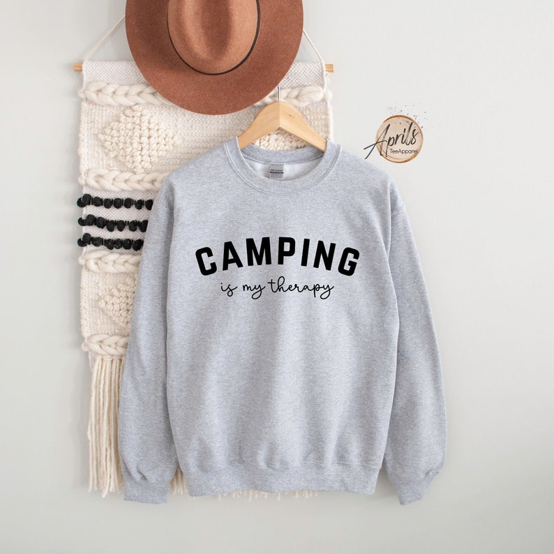May include: Gray sweatshirt with the text "CAMPING is my therapy" in black.
