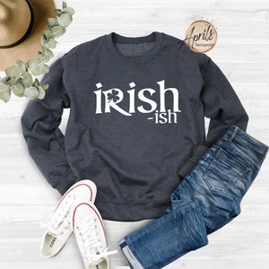 May include: A dark blue sweatshirt with the text "irish-ish" in white lettering. A shamrock is included in the word "irish".