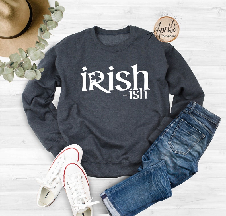 May include: A dark blue sweatshirt with the text "irish-ish" in white lettering. A shamrock is included in the word "irish".