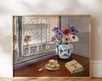 May include: A framed painting depicting a blue and white patterned vase filled with purple, red, and white flowers. A small cup on a saucer with a spoon and a book titled PASCAL sit on a brown table near a window with a sheer patterned curtain.