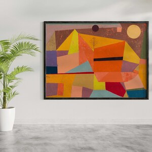 May include: Abstract geometric painting with a mix of orange, yellow, red, blue, green, and purple colors. The painting is framed in black and has a textured surface.