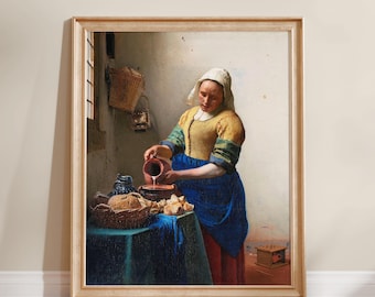 May include: A framed print of a painting depicting a person wearing a white head covering, a yellow bodice, and a blue apron, pouring milk from a brown pitcher into a bowl on a table covered with a green cloth, with bread and a basket nearby.