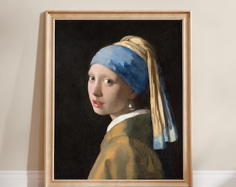May include: A framed art print featuring a portrait of a person wearing a blue headscarf and a yellow garment against a dark background. The subject has a single pearl earring visible on the left ear and is looking over their shoulder.