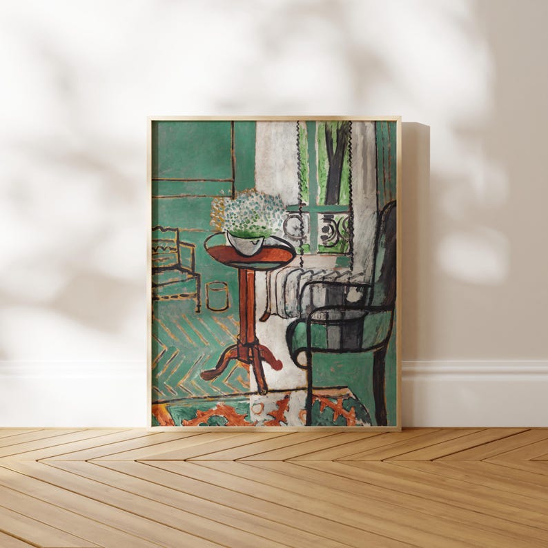 thin wood picture frame with fauvist painting of a table and chair in a green room